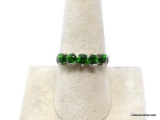 .925 STERLING SILVER RING WITH A ROW OF (5) ROUND CUT DARK GREEN GEMSTONES. MARKED ON THE INSIDE