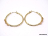 PAIR OF 14K YELLOW GOLD PIERCED HOOP EARRINGS WITH A ROW OF 3 GOLD FLOWER DETAILING ON EACH. MARKED