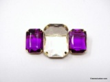 VINTAGE AVON GOLD TONE BROOCH WITH LARGE RECTANGULAR CUT AMETHYST & CLEAR COLORED RHINESTONES.