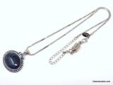 LIA SOPHIA OVAL SILVER TONE PENDANT WITH LARGE DARK BLUE GEMSTONE ACCENTED WITH A SMALLER ROUND CUT