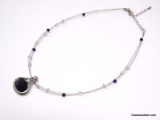 LIA SOPHIA SILVER TONE BAJA PENDANT FEATURING A LARGE OVAL CUT NAVY BLUE GEMSTONE ACCENTED WITH A