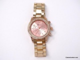 GENEVA ROSE GOLD TONE LADIES WRIST WATCH WITH CLEAR RHINESTONE BORDER. NEEDS A NEW BATTERY.