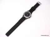 ATTENTION BRAND BLACK QUARTZ WRIST WATCH WITH A SILVER TONED & CZ BORDER. BLACK RUBBER BAND. NEEDS A