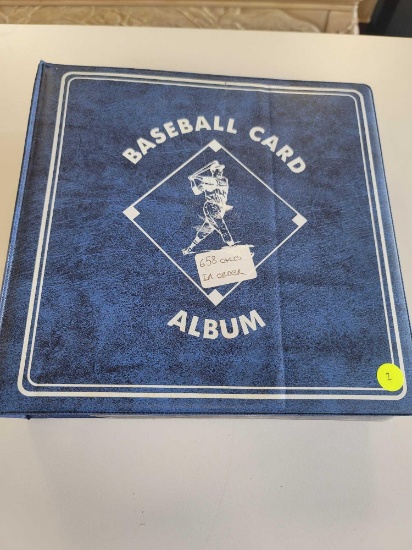 BLUE BASEBALL CARD ALBUM BINDER FILLED WITH ASSORTED BASEBALL CARDS. 658 IN TOTAL. TIM RAINES, MARK