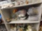 SHELF LOT OF ASSORTED DECOR ITEMS TO INCLUDE: WHITE WIRE ORGANIZER, HOSTA AND ELEPHANT EAR BULBS,