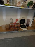 SHELF LOT OF MISC ITEMS, WAFFLE MAKER, BASKET FILLED WITH KITCHEN UTENSILS, AND 3 VARIOUS SIZED