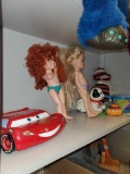 SHELF LOT OF MISC TOYS, LIGHTNING MCQUEEN, FISHER PRICE TOYS, 2 DOLLS, SOCK MONKEY.