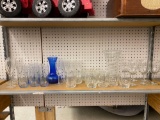 SHELF LOT OF ASSORTED GLASS TO INCLUDE MEDIUM STEM DRINKING GLASSES WITH A GOLD TONE TRIM AROUND THE