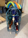 GREEN METAL 7 BOTTLE WINE RACK PORTABLE WITH EMPTY WINE BOTTLES, RACK HAS TWISTED VINES GOING UP THE