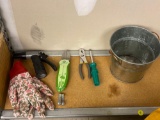 SHELF LOT OF A ASSORTED ITEMS SUCK AS A METAL BUCKET, AND GARDENING TOOLS