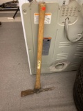 EARLY STYLE PICKAXE WITH A WOODEN HANDLE AND A RUSTED HEAD, MEASURING APPROXIMATELY 15 in x 34 in