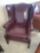 RED LEATHER WINGBACK ARMCHAIR, BRASS TACK ACCENTS, IS IN GOOD USED CONDITION, SOME NORMAL WEAR AND