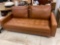 ABBYSON HOLLOWAY MID-CENTURY LEATHER SOFA IN CAMEL COLOR. RETAILS FOR $1,299.00. MODEL