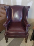 RED LEATHER WINGBACK ARMCHAIR, BRASS TACK ACCENTS, IS IN GOOD USED CONDITION, SOME NORMAL WEAR AND