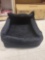 Black fuzzy pet booster seat for cars. Adjustable pet leash and headrest harness.