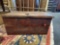 MEDIUM SIZED WOODEN CHEST; ONE LEATHER HINGE IS BROKEN; MEASURES 24 x 13 x 12