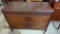 EARLY STYLE MAHOGANY 4 DRAWER DRESSER ON WHEELS MEASURES APPROXIMATELY 46 IN X 20 IN X 36 IN DRESSER