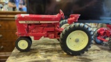 ETRL MODEL TRACTOR, INTERNATIONAL, RED, THE PAINT IS CHIPPING. 8 1/4