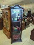 CONTEMPORARY DARK STAINED WOOD & GLASS CURIO CABINET WITH TWO GLASS SHELVES. BRASS PULL ON THE DOOR,