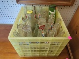 CRATE FULL OF VINTAGE SODA BOTTLES & A GLASS JUG. APPROX. 24 PIECES. INCLUDES PEPSI, 7UP, & COKE.