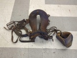 VINTAGE LEATHER HORSE SADDLE WITH ONE WOODEN STIRRUP & A METAL STIRRUP. CONDITION IS CONSISTENT WITH