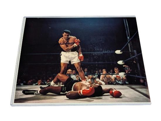 UNFRAMED & AUTOGRAPHED PHOTO OF MUHAMMAD ALI. COMES WITH A PLASTIC PROTECTIVE SLEEVE. IT MEASURES