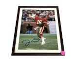 FRAMED & AUTOGRAPHED PHOTO OF JOE MONTANA. DISPLAYED IN A BROWN FRAME. IT MEASURES APPROX. 9-1/2