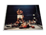 UNFRAMED & AUTOGRAPHED PHOTO OF MUHAMMAD ALI. COMES WITH A PLASTIC PROTECTIVE SLEEVE. IT MEASURES