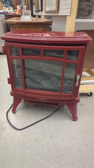 ELECTRIC FAUX FIREPLACE IN COLOR RED, MEASURES APPROXIMATELY 21 IN X 11 IN X 24 IN.