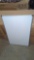BRAND NEW WHITE BOARD, STILL PLASTIC WRAPPED, DOES HAVE A DENT IN THE WHITE BOARD