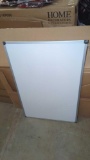 BRAND NEW WHITE BOARD, STILL PLASTIC WRAPPED, DOES HAVE A DENT IN THE WHITE BOARD