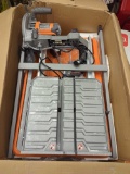 RIDGID 9 Amp 7 in. Blade Corded Wet Tile Saw with Stand. Comes in opened box, in heavily used