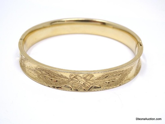 VERY NICE 14K YELLOW GOLD BANGLE BRACELET WITH ENGRAVED FLORAL DETAILING. MARKED "14K". IT MEASURES