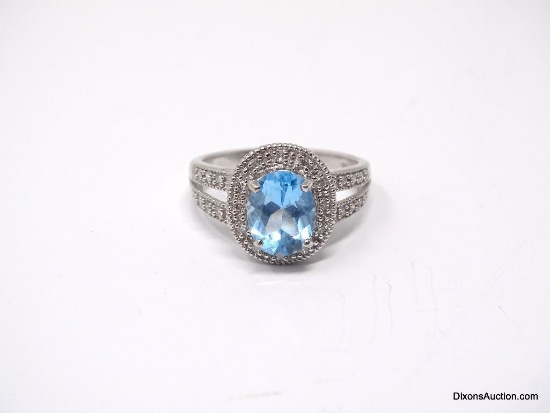 10K WHITE GOLD RING WITH OVAL CUT PRONG SET AQUAMARINE GEMSTONE, ACCENTED WITH SMALL DIAMOND CHIPS.