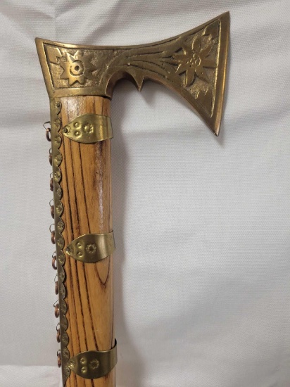 APPEARS TO BE BRASS HANDLED TOMAHAWK STYLE WOODEN CANE. CANE MEASURES APPROX. 35".