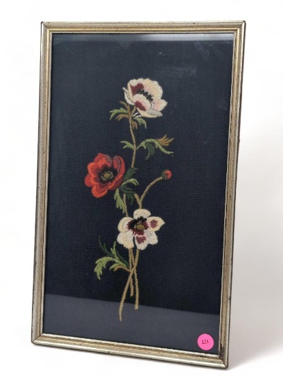 (FOYER) VINTAGE HAND STITCHED FLORAL ART, DISPLAYED IN A SILVER TONED FRAME. IT MEASURES APPROX.