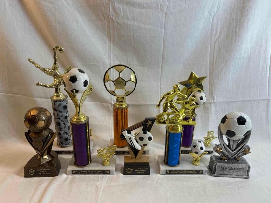 Assorted soccer trophies ranging from 7 to 13 inches tall.