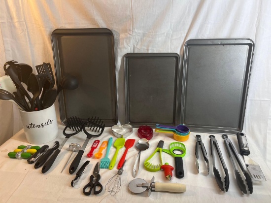 Kitchen lot including baking sheets, utensils, tongs, various kitchen tools