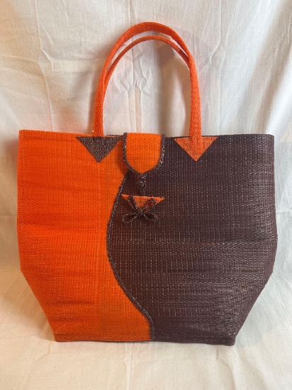 Woven straw textured orange and brown purse. 15.5" tall.