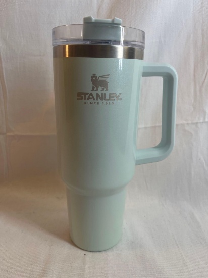 Large Stanley insulated mug with lid and handle in mint green.