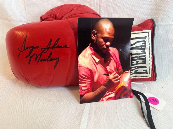 Autographed Everlast Boxing Glove signed by Sugar Shane Mosley with photo of signing.