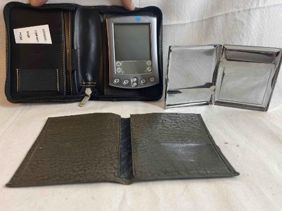 Palm pilot with wallet case, decorative...metal cigarette...case, leather wallet.