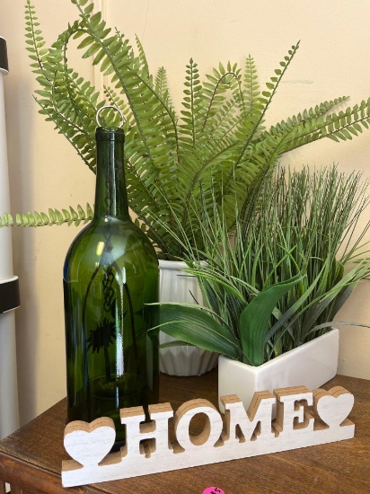 Home decor. Plants, wooden art, bottle.