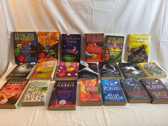 Large lot of paperback books by Nora Roberts, Charlaine Harris, and E. L. James....
