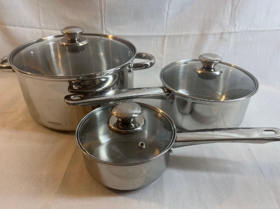Set of three stainless steel pots with lids
