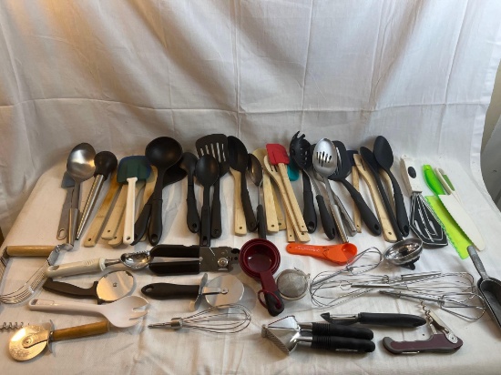 Large lot of kitchen utensils - spoons, spatulas, measuring cups, pizza cutters, garlic press, etc.