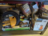 Box lot of assorted items including 100-ft professional duty hose, 2-in-1 utility pump, front