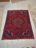 HAND MADE ANTIQUE AREA RUG. FLORAL ACCENTS, RED, AND DARK BLUE. 44 1/2