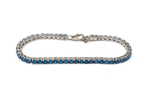 .925 STERLING SILVER TENNIS BRACELET FEATURING A SINGLE ROW OF PRONG SET ROUND CUT SIMULATED BLUE