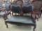 Wood and Faux Leather Settee With Carved Details